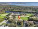 Home's location highlighted in an aerial view by a lake at 6220 Topsail Rd, Lady Lake, FL 32159