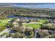 Aerial view showing a community of homes near a lake and waterfront at 6220 Topsail Rd, Lady Lake, FL 32159