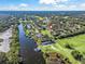 Wide aerial view of house location near water and golf course at 6220 Topsail Rd, Lady Lake, FL 32159