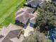 Aerial view of house and neighborhood, highlighting driveway and roofline at 6220 Topsail Rd, Lady Lake, FL 32159