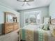 Bright bedroom with bay window, dresser, and king-size bed at 6220 Topsail Rd, Lady Lake, FL 32159