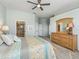 Primary bedroom with king-size bed, dresser, and walk-in closet at 6220 Topsail Rd, Lady Lake, FL 32159