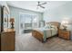 Spacious bedroom with a queen bed and bay window at 6220 Topsail Rd, Lady Lake, FL 32159