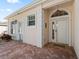 Front entry with white door and brick walkway at 6220 Topsail Rd, Lady Lake, FL 32159