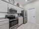 Kitchen boasts stainless steel appliances and light colored cabinetry at 6220 Topsail Rd, Lady Lake, FL 32159