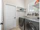 Laundry room with washer, dryer, and extra shelving at 6220 Topsail Rd, Lady Lake, FL 32159