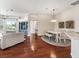 Living room with hardwood floors, and a view into the kitchen and dining area at 6220 Topsail Rd, Lady Lake, FL 32159