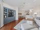 Living room with hardwood floors, built-in shelving and view into dining area at 6220 Topsail Rd, Lady Lake, FL 32159