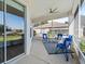 Relaxing screened porch with seating area and ceiling fan at 6220 Topsail Rd, Lady Lake, FL 32159