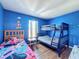 Mickey Mouse themed bedroom with bunk beds and wood-look floors at 647 Calabria Ave, Davenport, FL 33897