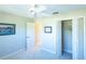 Bright bedroom with double door closet and carpet flooring at 670 Murphys Estate Dr, The Villages, FL 32162