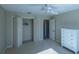 Bedroom with ceiling fan, dresser, and double door closet at 670 Murphys Estate Dr, The Villages, FL 32162