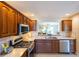 Kitchen with wood cabinets, stainless steel appliances at 670 Murphys Estate Dr, The Villages, FL 32162