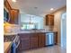 Kitchen with stainless steel appliances and wood cabinets at 670 Murphys Estate Dr, The Villages, FL 32162