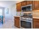 Kitchen with stainless steel appliances and wood cabinets at 670 Murphys Estate Dr, The Villages, FL 32162