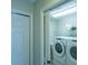 Laundry room with washer, dryer, and shelving at 670 Murphys Estate Dr, The Villages, FL 32162