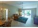 Living room with leather couch, wicker chairs, and access to a patio at 670 Murphys Estate Dr, The Villages, FL 32162