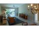 Living room with view of patio, rug, and entertainment center at 670 Murphys Estate Dr, The Villages, FL 32162