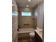 Clean bathroom featuring a tub, toilet, and modern vanity at 6851 Wendy Way, The Villages, FL 32163