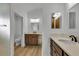 Modern bathroom with dual vanity and light wood cabinets at 6851 Wendy Way, The Villages, FL 34762