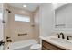 Bathroom with tub, shower, vanity, and neutral tile at 6851 Wendy Way, The Villages, FL 34762