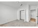 Bedroom with ceiling fan, carpet, and double doors to closet at 6851 Wendy Way, The Villages, FL 34762