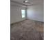 Spacious bedroom with carpeted floors and large window at 6851 Wendy Way, The Villages, FL 32163