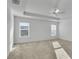 Large bedroom with carpet flooring, ceiling fan, and two windows at 6851 Wendy Way, The Villages, FL 34762