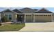 Attractive single-story home with two-car garage and landscaped lawn at 6851 Wendy Way, The Villages, FL 32163