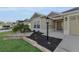 Landscaped front yard with stone wall and palm trees at 6851 Wendy Way, The Villages, FL 34762