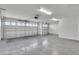 Spacious two-car garage with painted floor and extra storage at 6851 Wendy Way, The Villages, FL 34762