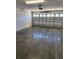 Bright two-car garage featuring polished concrete floors at 6851 Wendy Way, The Villages, FL 32163