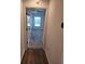 Hallway with wood-look flooring leading to bedroom at 6851 Wendy Way, The Villages, FL 32163