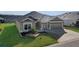 Front view of house, two car garage, and landscaping at 6851 Wendy Way, The Villages, FL 34762