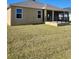 Back exterior of house showcasing a large covered patio at 6851 Wendy Way, The Villages, FL 32163