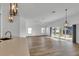 Open concept kitchen with light cabinets and quartz countertops at 6851 Wendy Way, The Villages, FL 34762