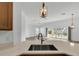 Modern kitchen with island and view of living room and patio at 6851 Wendy Way, The Villages, FL 34762