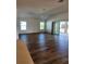 Spacious living room featuring hardwood floors and sliding glass doors at 6851 Wendy Way, The Villages, FL 32163