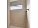 Large walk-in shower with beige tile and built-in seat at 6851 Wendy Way, The Villages, FL 34762