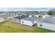 Aerial view showcasing a row of houses with lush green lawns at 7189 Denver Ave, The Villages, FL 34762