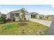 Two-story home with gray and white siding, landscaped yard at 7189 Denver Ave, The Villages, FL 34762