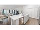 Kitchen island with double sink and breakfast bar overlooking living room at 7189 Denver Ave, The Villages, FL 34762