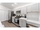 Modern kitchen with stainless steel appliances and gray cabinets at 7189 Denver Ave, The Villages, FL 34762