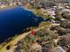 Aerial view of waterfront land plot; serene setting at 73 N Carol Ave, Mascotte, FL 34753