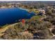 Aerial view of land plot near lake and homes at 73 N Carol Ave, Mascotte, FL 34753