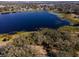 Aerial view showing a home's location on lake with private lot at 73 N Carol Ave, Mascotte, FL 34753