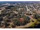 Aerial view of land plot near lake and town at 73 N Carol Ave, Mascotte, FL 34753