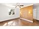 Bedroom with hardwood floors, ceiling fan and wood accent wall at 73 N Carol Ave, Mascotte, FL 34753