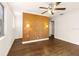 Bedroom with wood walls, ceiling fan and hardwood floors at 73 N Carol Ave, Mascotte, FL 34753