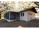 Tan house with screened porch and partial view of the lake at 73 N Carol Ave, Mascotte, FL 34753